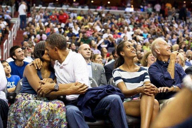 Barack Obama kisses Michelle Obama for the “Kiss Cam” while attending the U.S. Men’s Olympic basketball team’s game against Brazil at the Verizon Center in Washington, on July 16, 2012.